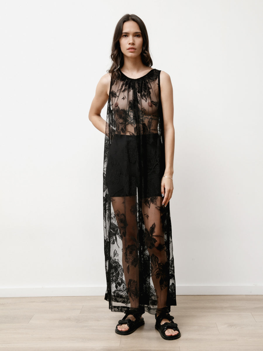 Woman wearing detailed black sheer lace maxi dress